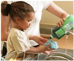 The little girl is doing the washing up