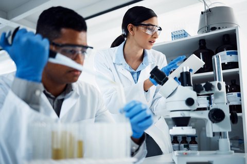 yayimages 45314398 hard at work in the name of health shot of two young scientists using a digital